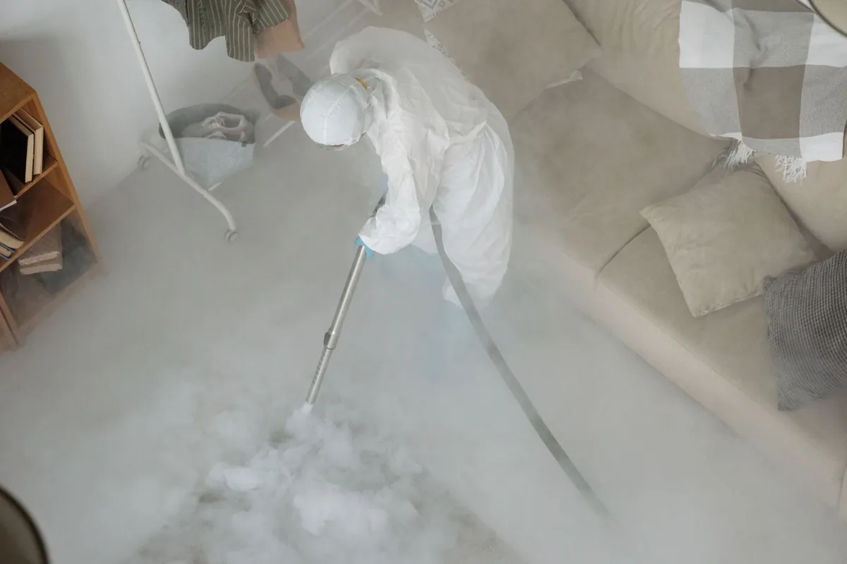 Biohazard cleanup technician in protective equipment, Evergreen, MT